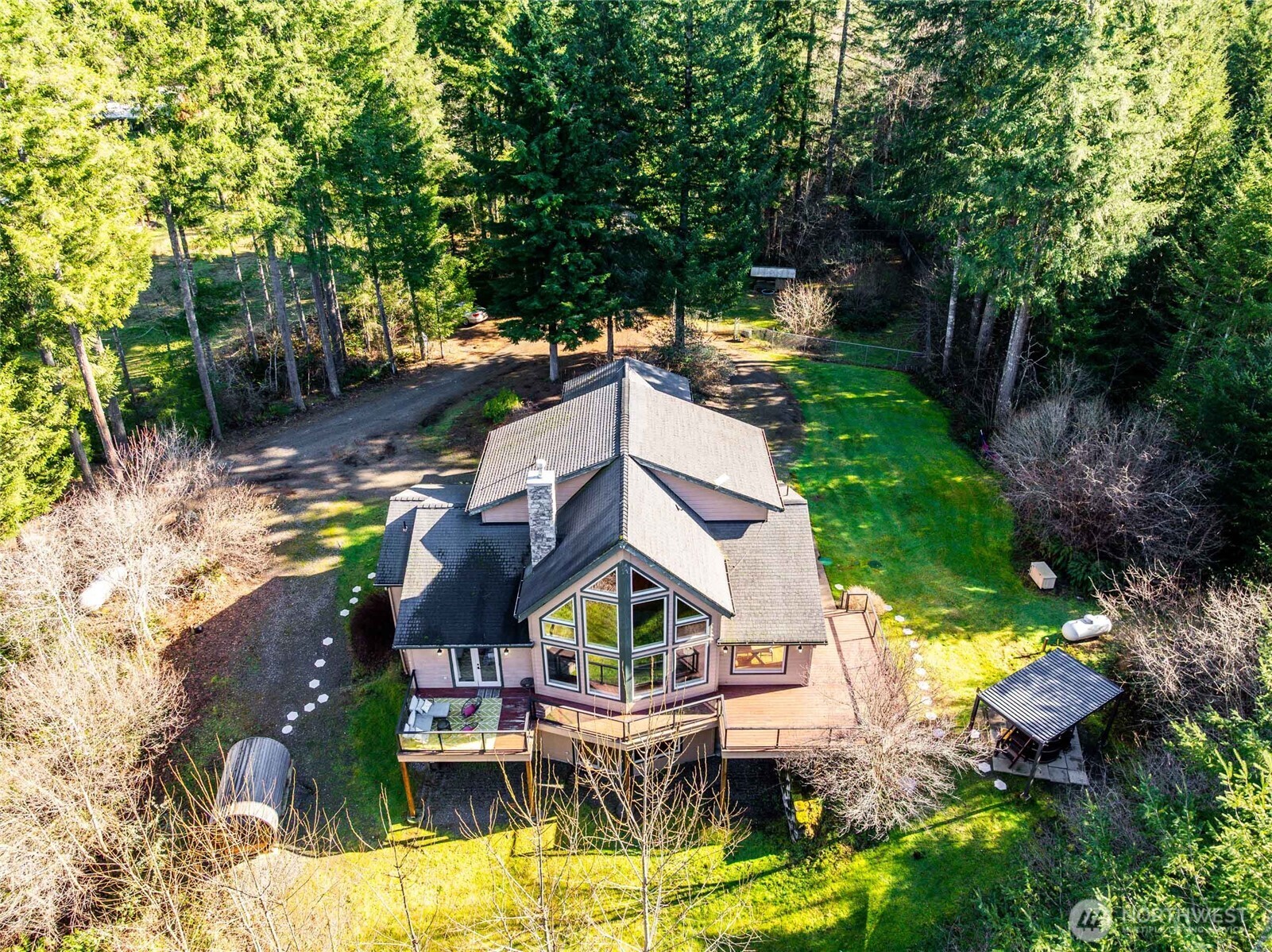 a aerial view of a house with swimming pool garden and patio