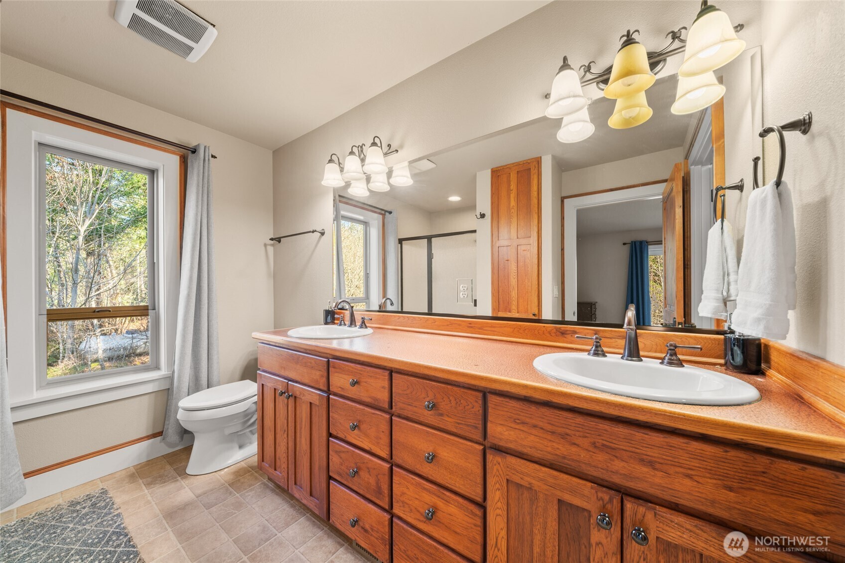 340 Arrowhead Road Ariel, WA 98603 - Photo 12 of 40 a bathroom with a double vanity sink and a mirror