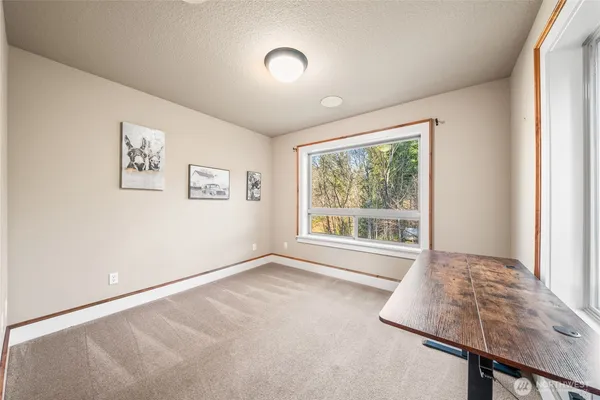 a bathroom with a sink a toilet and a window