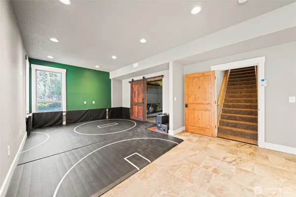 a big room with wooden floor and balcony