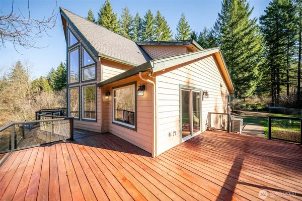 a view of a house with backyard and sitting area