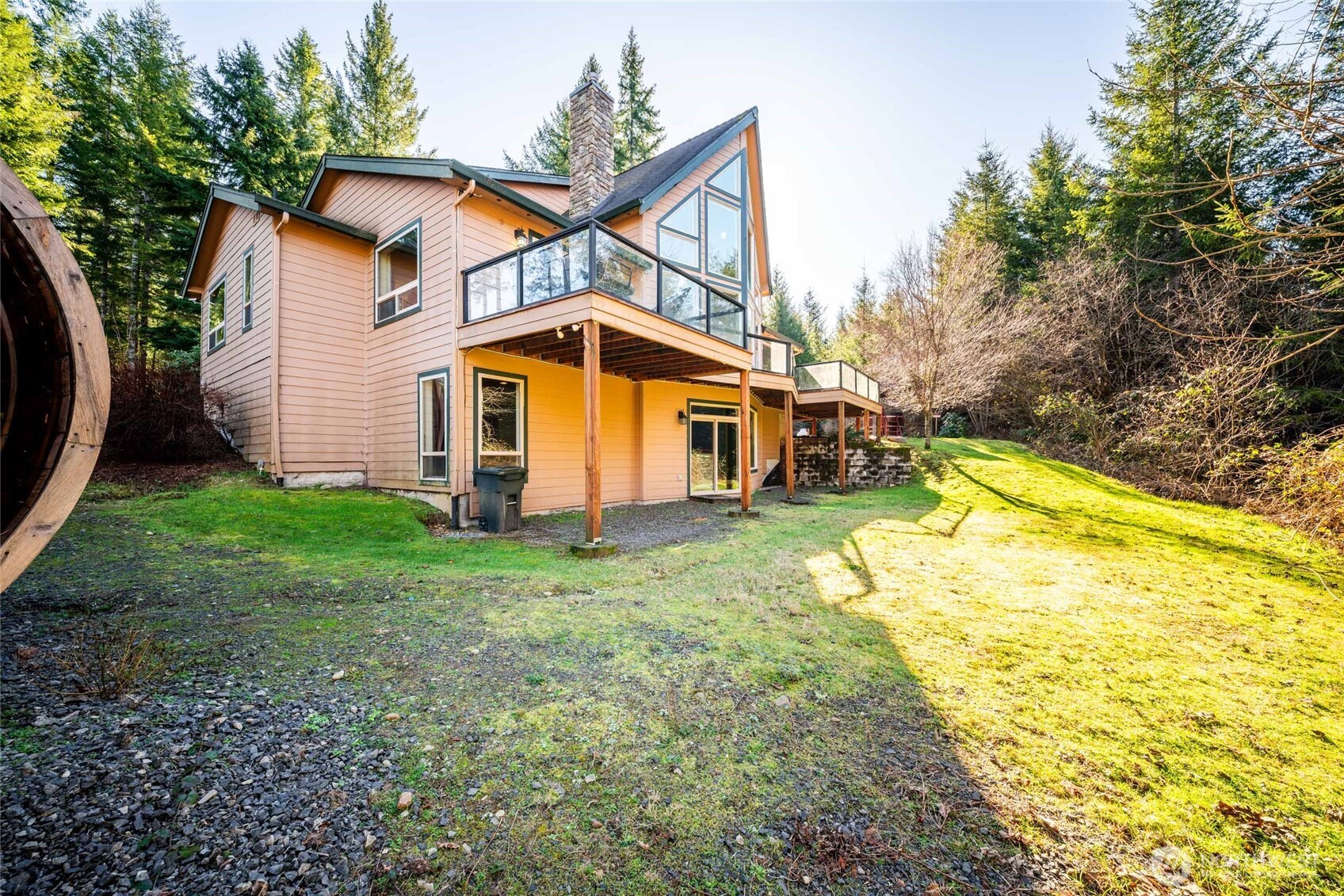 340 Arrowhead Road Ariel, WA 98603 - Photo 28 of 40 a view of a house with backyard and a small cabin