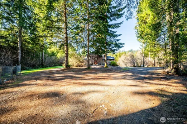 a view of a house with swimming pool and yard