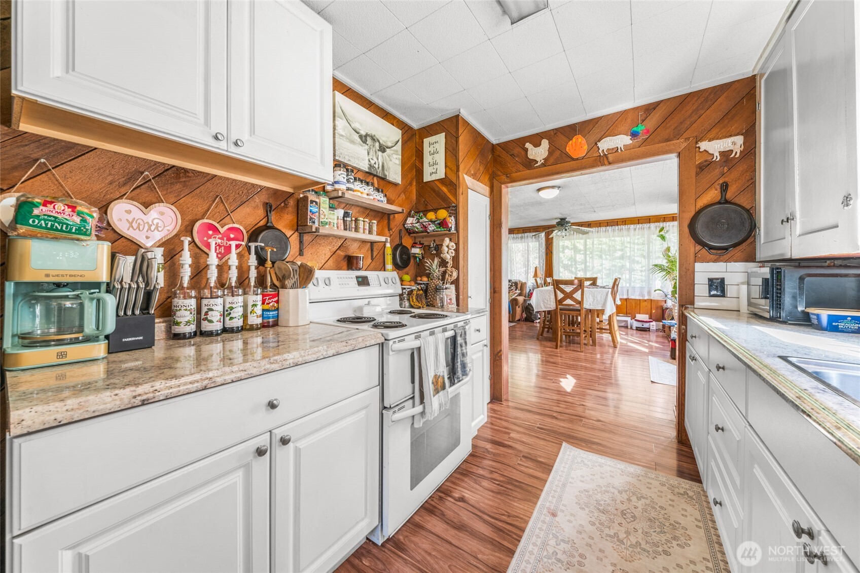 340 Arrowhead Road Ariel, WA 98603 - Photo 34 of 40 a kitchen with stainless steel appliances granite countertop a lot of counter space and wooden floors