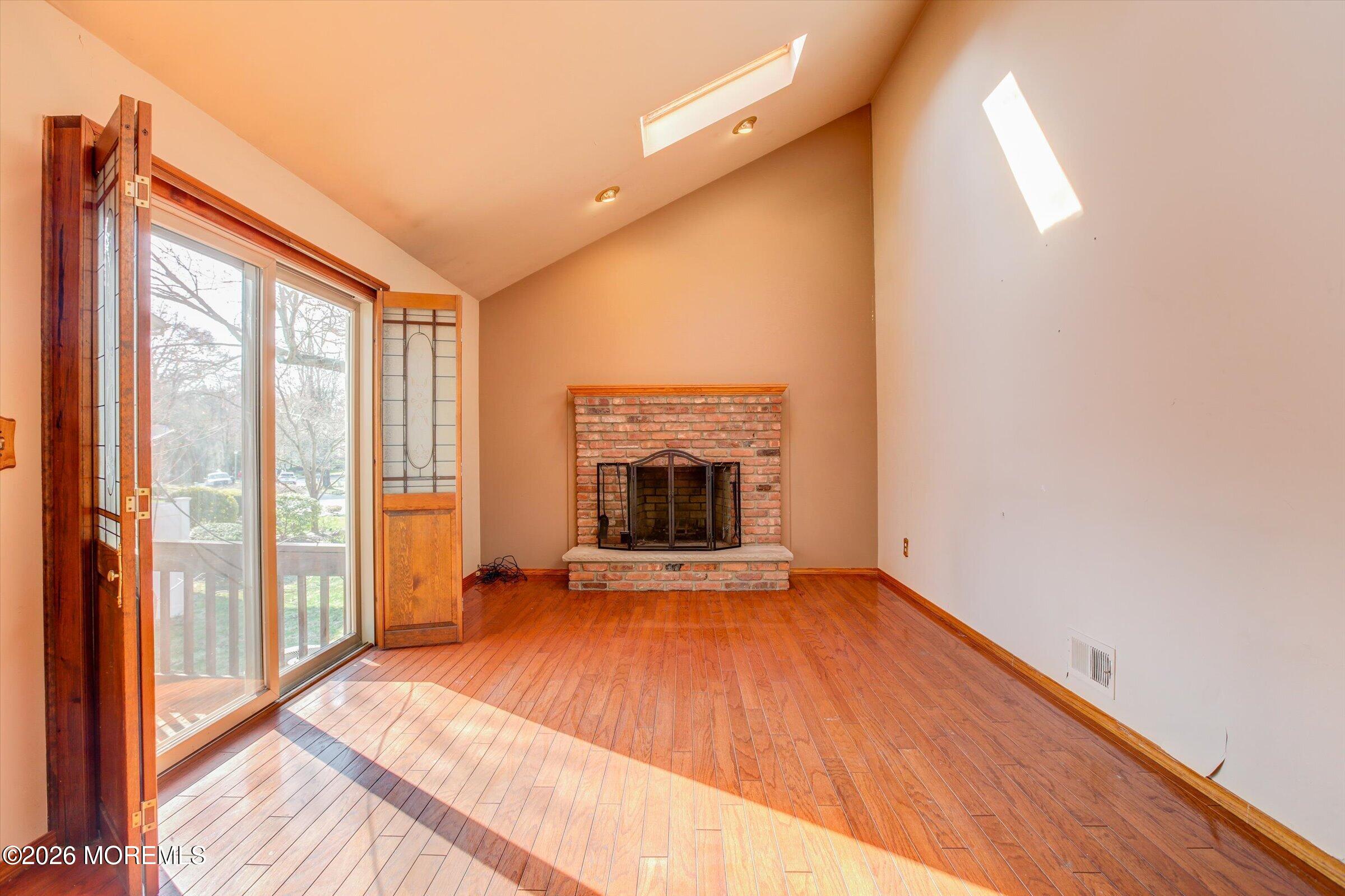 18 Warne Road Matawan, NJ 07747 - Photo 13 of 28 a view of an empty room with a fireplace and a window