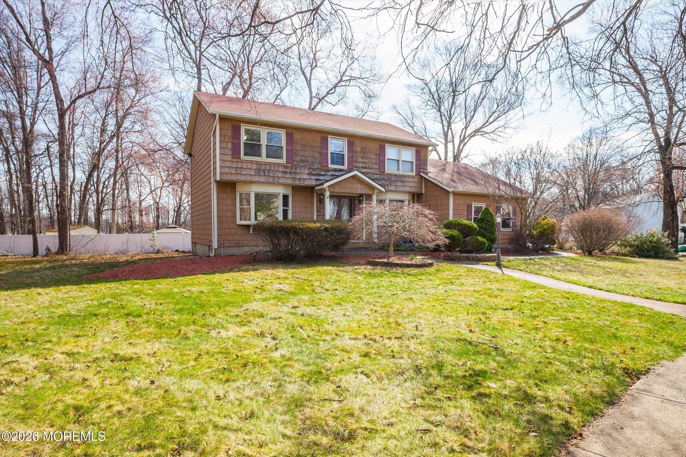 18 Warne Road Matawan, NJ 07747 - Photo 2 of 28 a front view of a house with a yard and trees