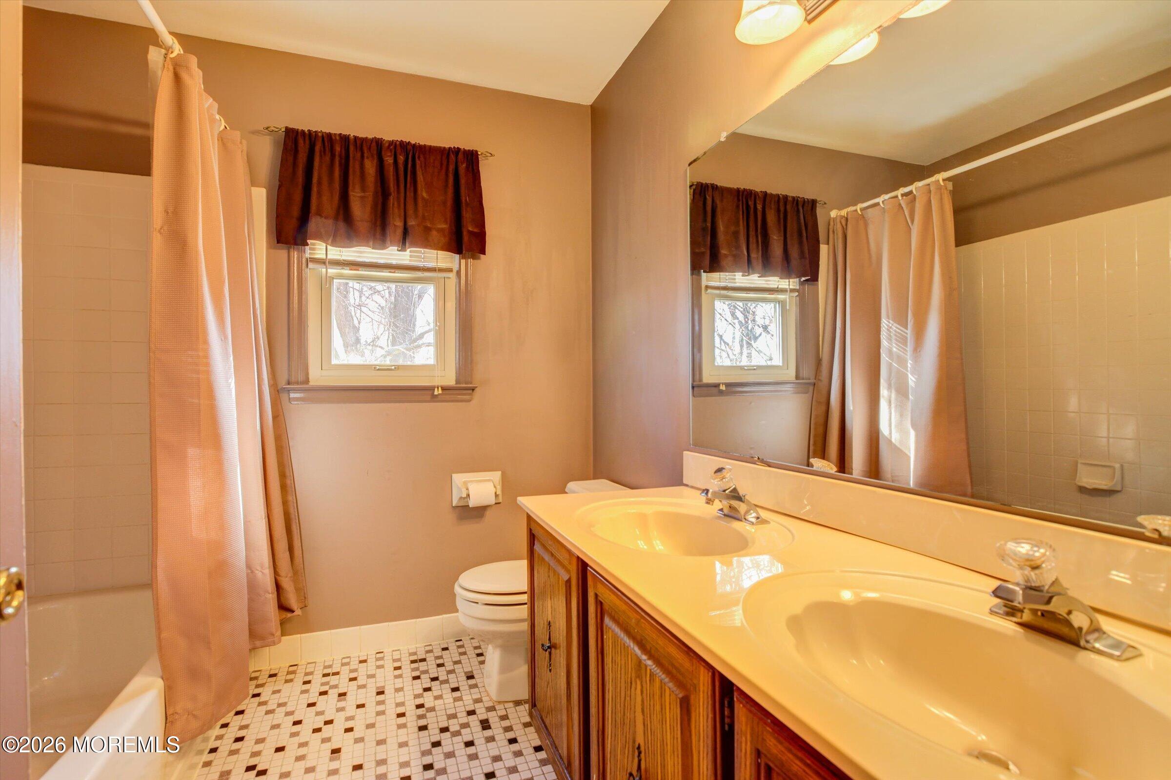 18 Warne Road Matawan, NJ 07747 - Photo 23 of 28 a bathroom with a sink and a mirror