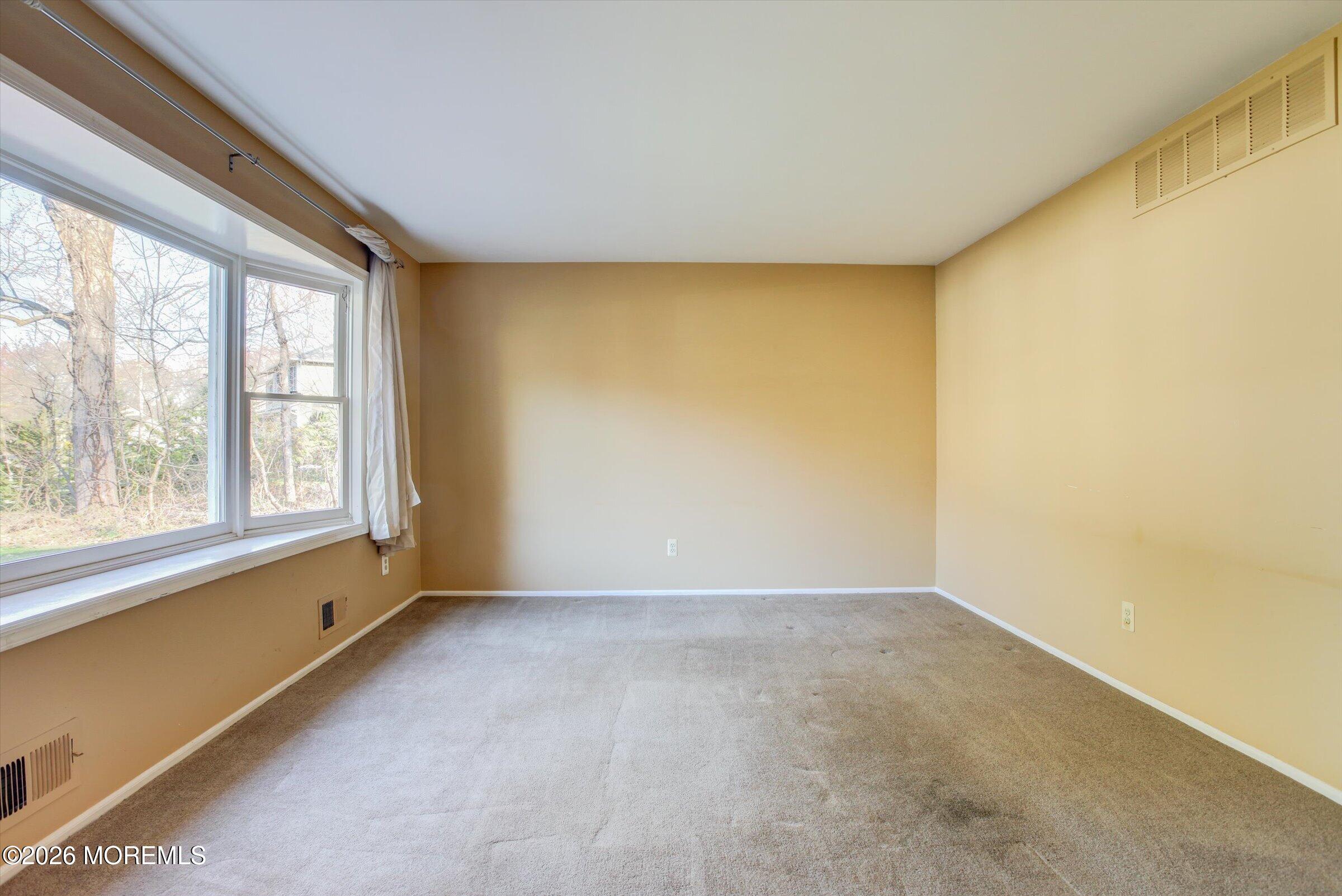 18 Warne Road Matawan, NJ 07747 - Photo 6 of 28 a view of an empty room with a window