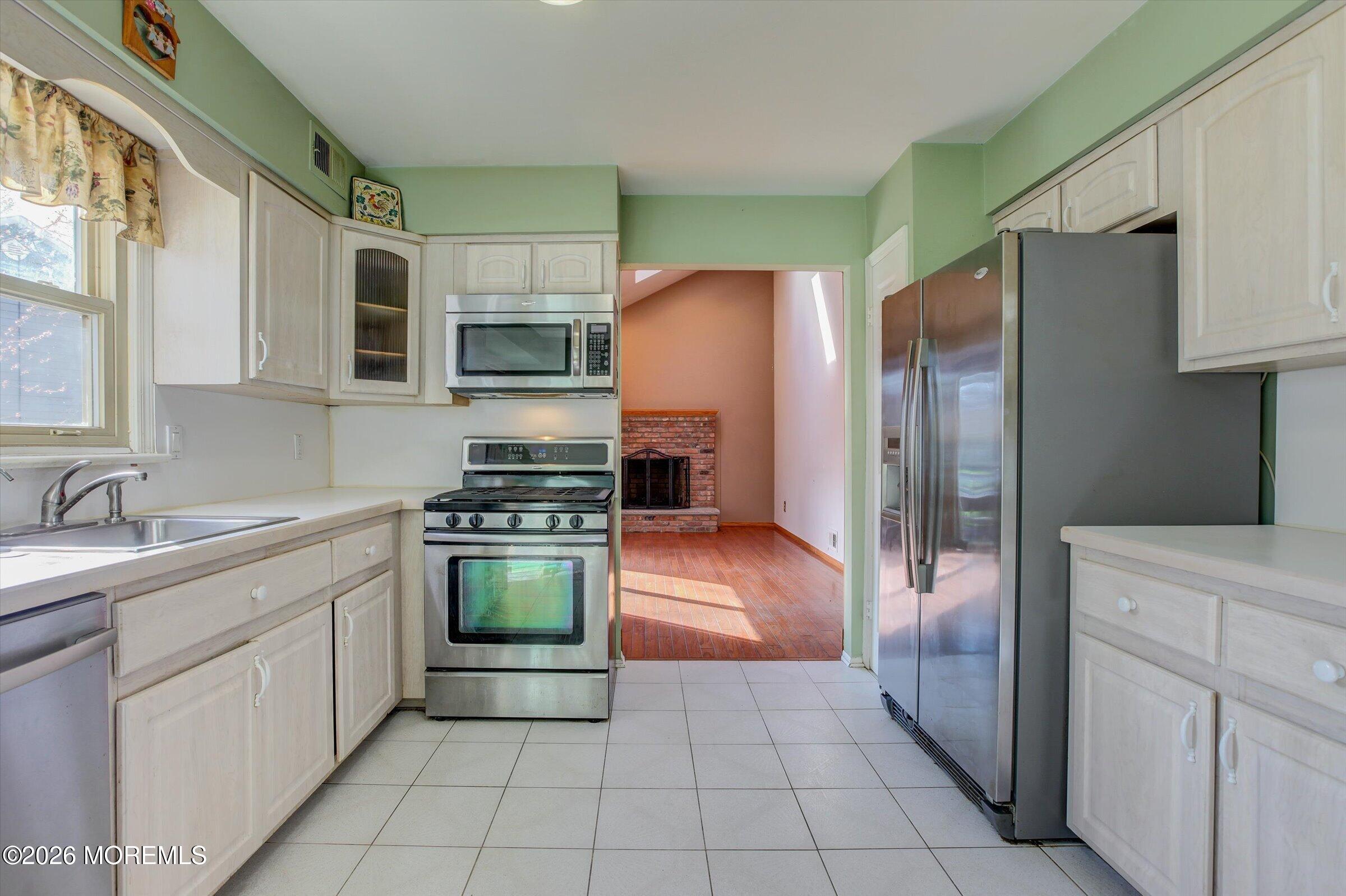 18 Warne Road Matawan, NJ 07747 - Photo 10 of 28 a kitchen with stainless steel appliances granite countertop a refrigerator and a stove top oven
