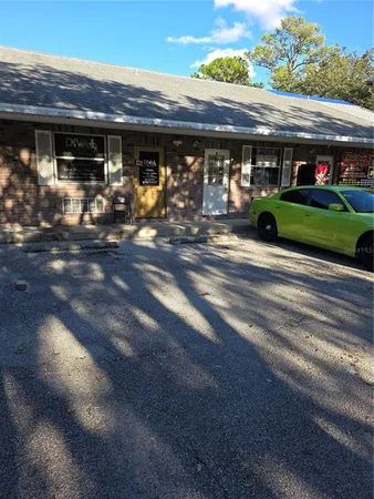 a view of a porch with furniture and potted plants