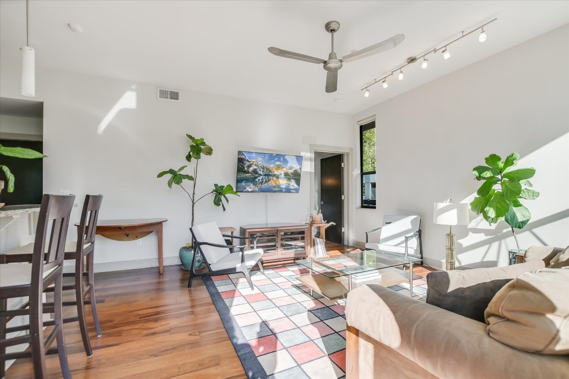 1320 Robert Browning Street, Unit 109 Austin, TX 78723 - Photo 2 of 16 a living room with furniture and a wooden floor