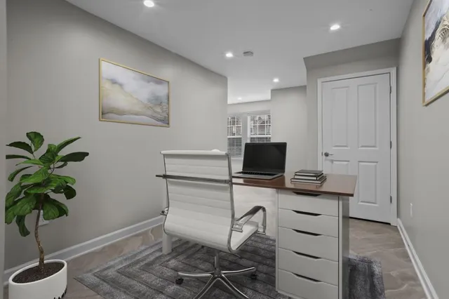 a workspace with furniture and a potted plant