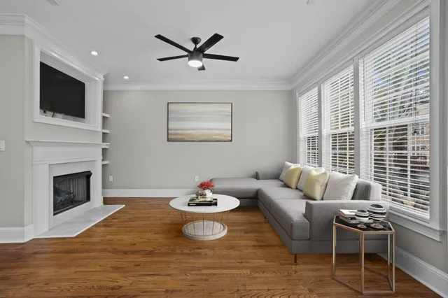 a view of a kitchen with wooden floor and a ceiling fan