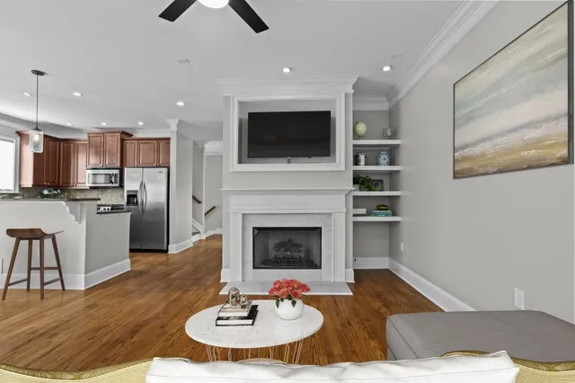 a view of a kitchen with wooden floor and a ceiling fan