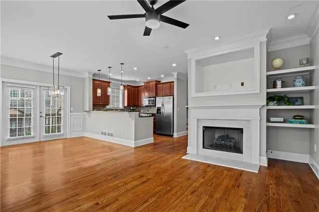a spacious bedroom with a bed and a flat screen tv