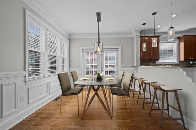 a view of a dining room with furniture window and wooden floor