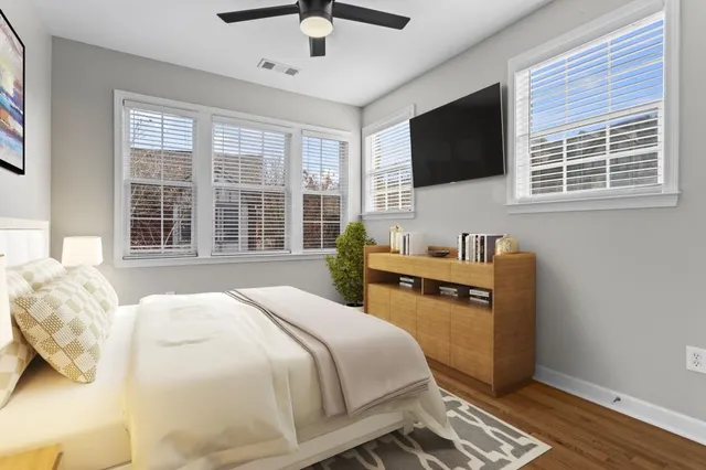 a bedroom with a bed and wooden floor