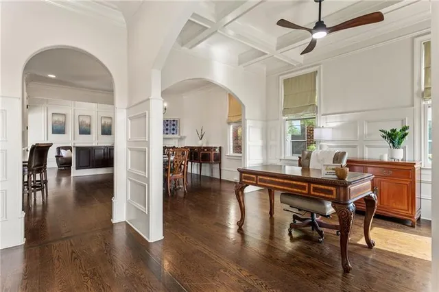 a view of a dining room with furniture a chandelier and wooden floor