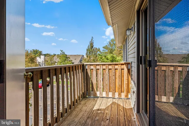 a view of a balcony with wooden floor