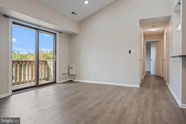 a view of an empty room with glass door