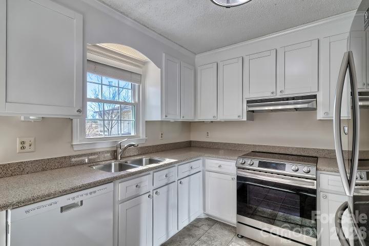1139 Merribrook Lane Lancaster, SC 29720 - Photo 12 of 37 a kitchen with granite countertop a sink stove and cabinets