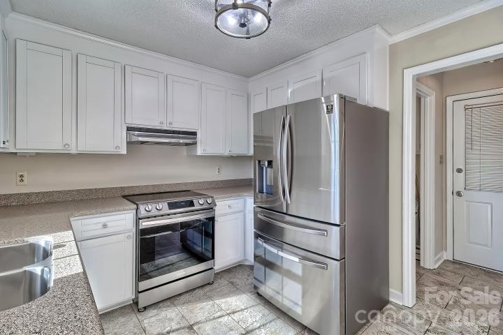 1139 Merribrook Lane Lancaster, SC 29720 - Photo 13 of 37 a kitchen with stainless steel appliances granite countertop a refrigerator a stove and a sink