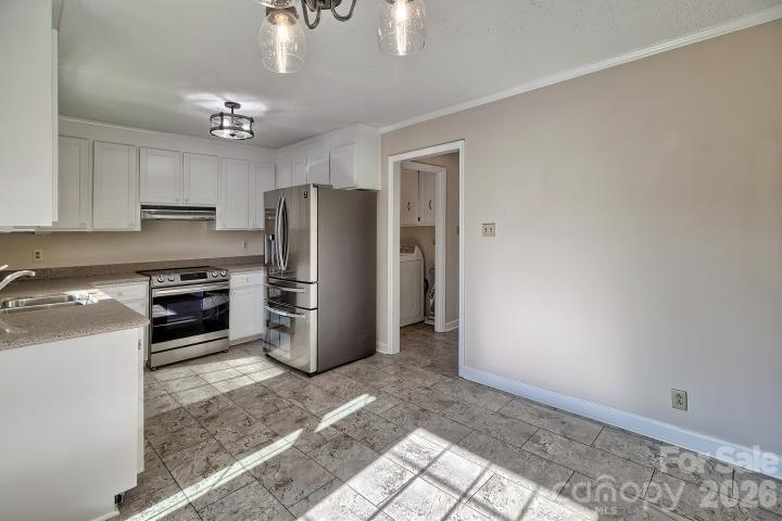 1139 Merribrook Lane Lancaster, SC 29720 - Photo 14 of 37 a kitchen with refrigerator a microwave a stove and cabinets