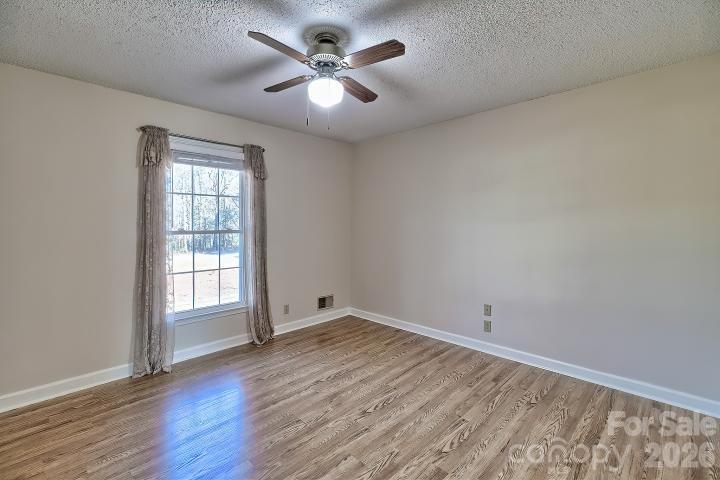 1139 Merribrook Lane Lancaster, SC 29720 - Photo 20 of 37 an empty room with wooden floor and windows
