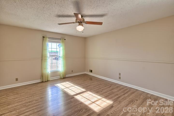 1139 Merribrook Lane Lancaster, SC 29720 - Photo 23 of 37 an empty room with wooden floor fan and windows