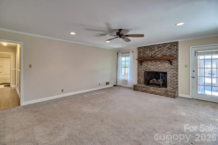 1139 Merribrook Lane Lancaster, SC 29720 - Photo 8 of 37 a view of an empty room with a fireplace and a window