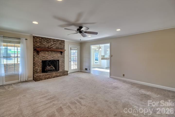 1139 Merribrook Lane Lancaster, SC 29720 - Photo 9 of 37 a view of an empty room with a fireplace and a window