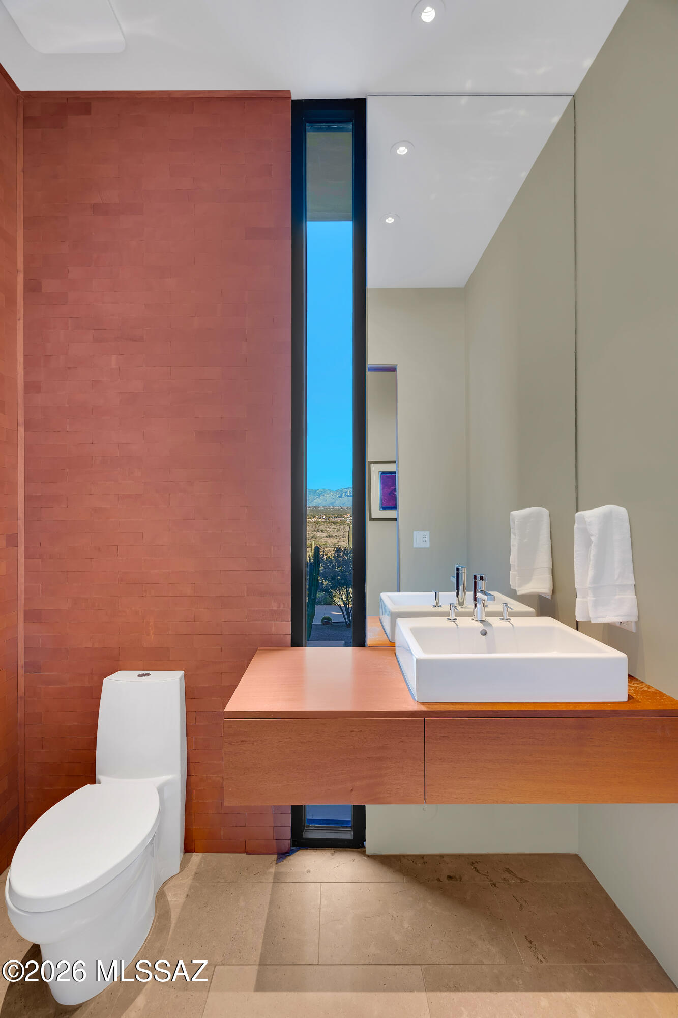 9971 North Silverbell Road Marana, AZ 85653 - Photo 23 of 34 a bath room with a toilet sink and mirror