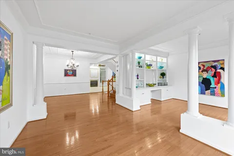 a view of empty room with window and ceiling fan