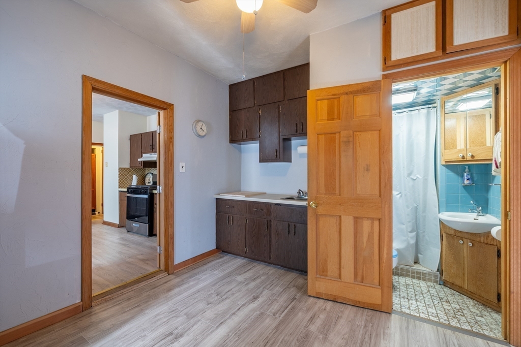417-419 Ferry Street Everett, MA 02149 - Photo 33 of 42 a kitchen with stainless steel appliances granite countertop a refrigerator and a sink