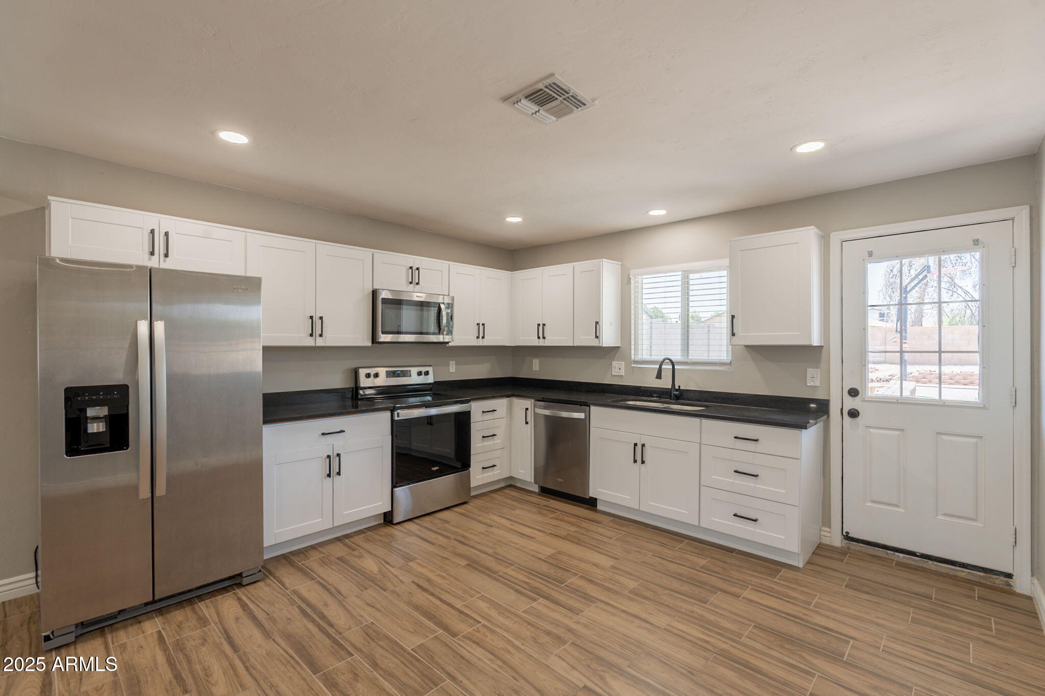 4001 East Apollo Road Phoenix, AZ 85042 - Photo 3 of 42 a kitchen with granite countertop a refrigerator stove top oven and sink