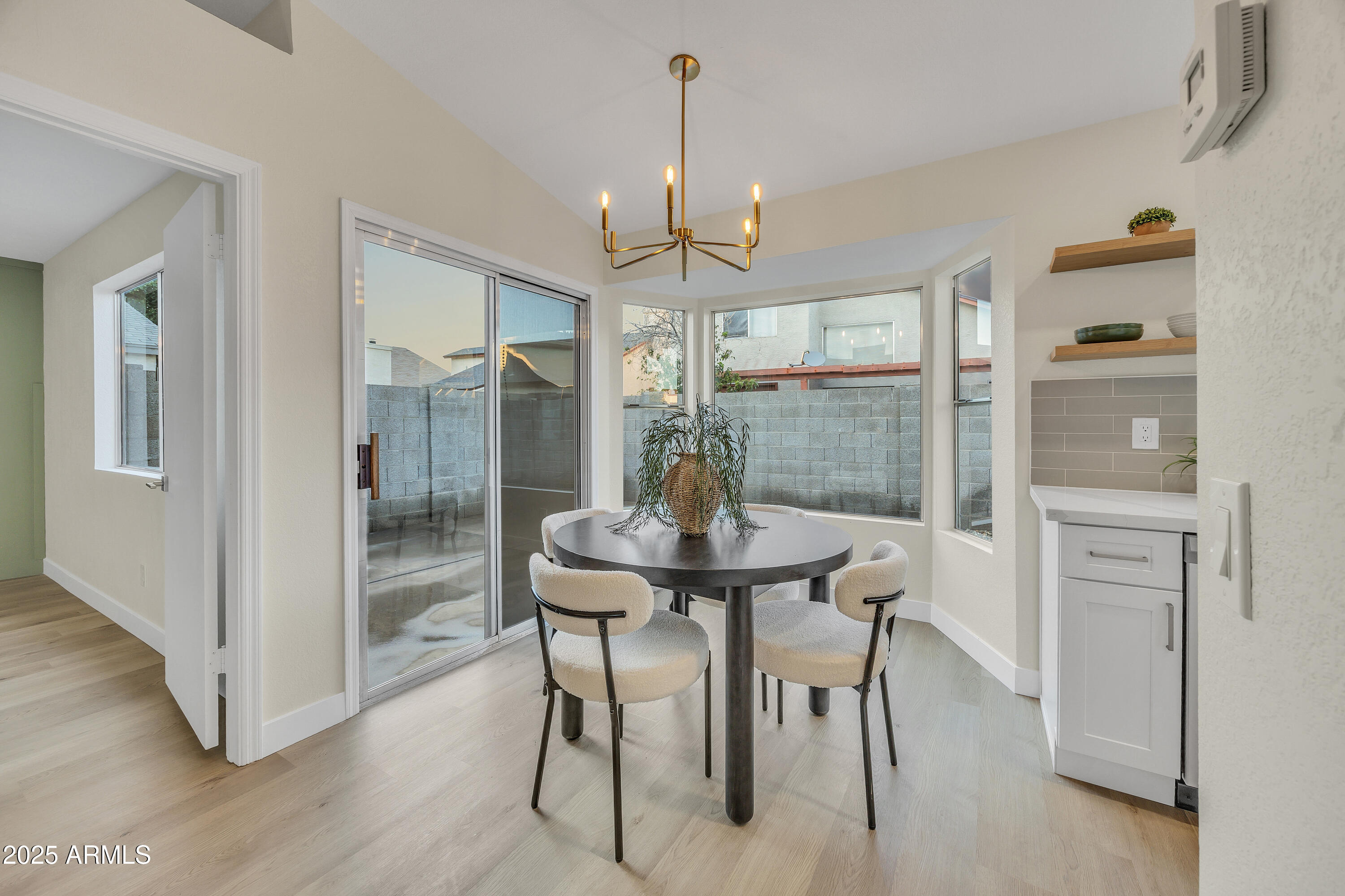8830 West St John Road Peoria, AZ 85382 - Photo 8 of 25 a view of a dining room with furniture window and wooden floor
