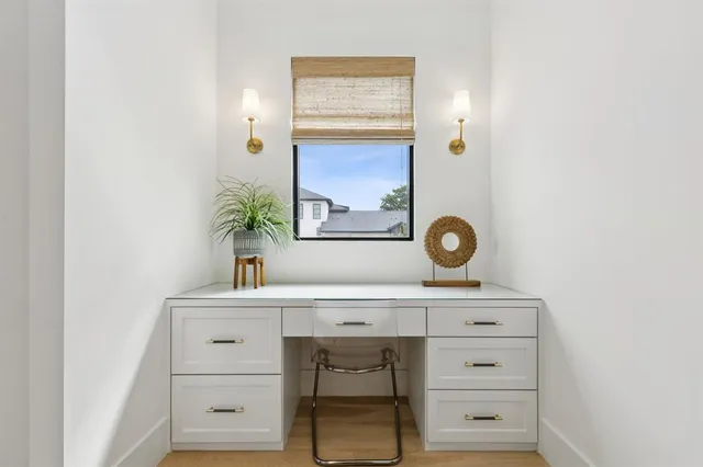 a view of cabinets a mirror and a lamp on a dresser
