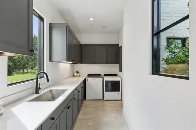 a kitchen with a sink a stove and a microwave