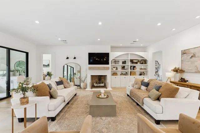 a living room with furniture a fireplace and a flat screen tv
