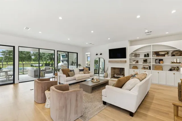 a living room with furniture fireplace and flat screen tv
