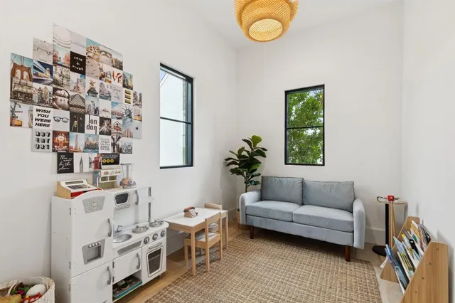 a living room with furniture a rug and a window