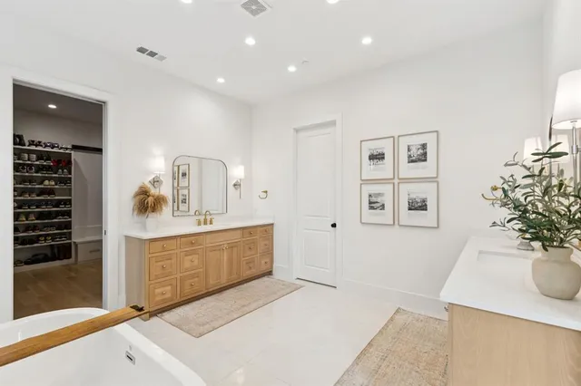 a spacious bathroom with a sink and a mirror