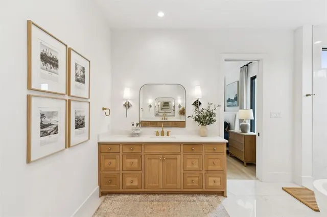 a bathroom with a double vanity sink mirror and