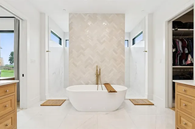 a bathroom with a bathtub and shower