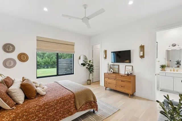 a bedroom with furniture and a flat screen tv