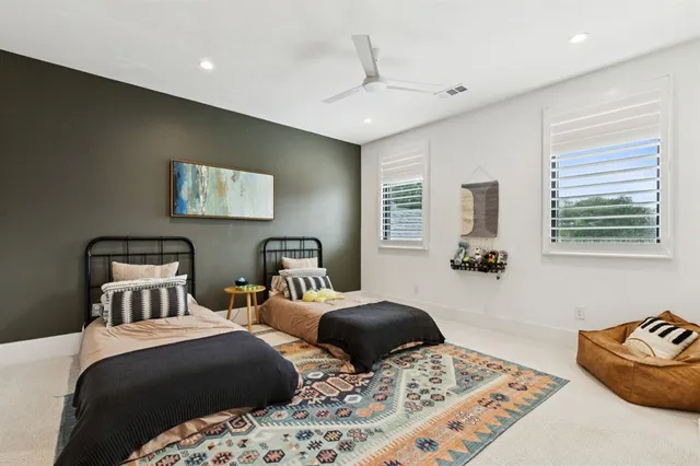 a bedroom with two beds and a couch