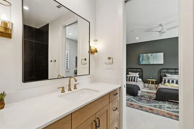 a en suite bathroom with a sink and mirror