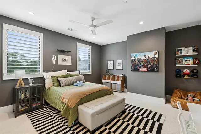 a bedroom with a bed a couch and a large window