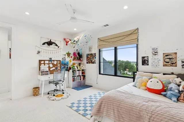 a bedroom with a bed a large window with the outer view