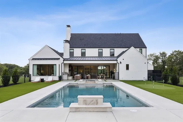 a view of house with swimming pool yard and green space